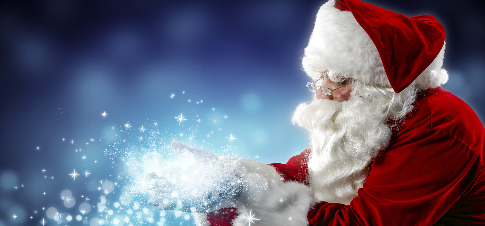 Photo of Santa blowing magic dust.